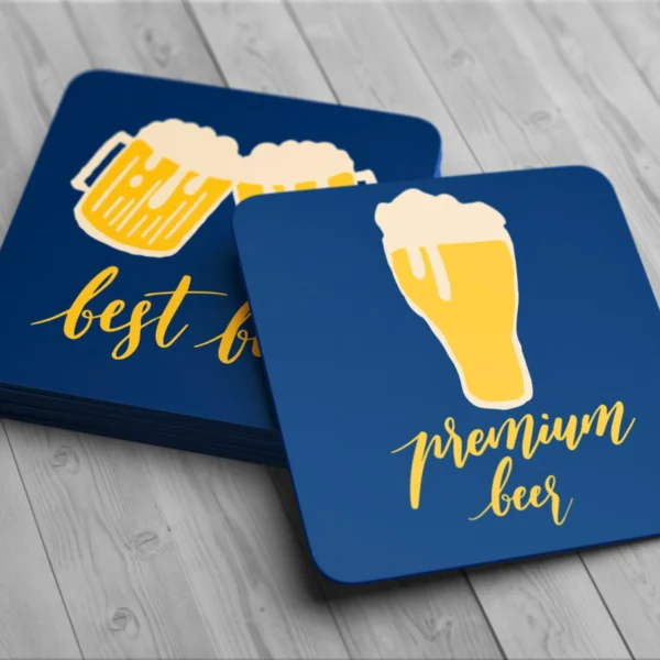 Colorful drink coasters featuring beer graphics on a wooden table.